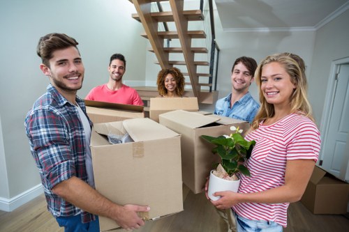 Mover handling boxes with safety focus at the start of a removals job