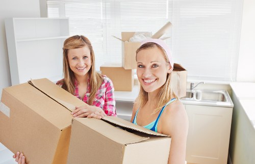Local removals team handling furniture in a residential move
